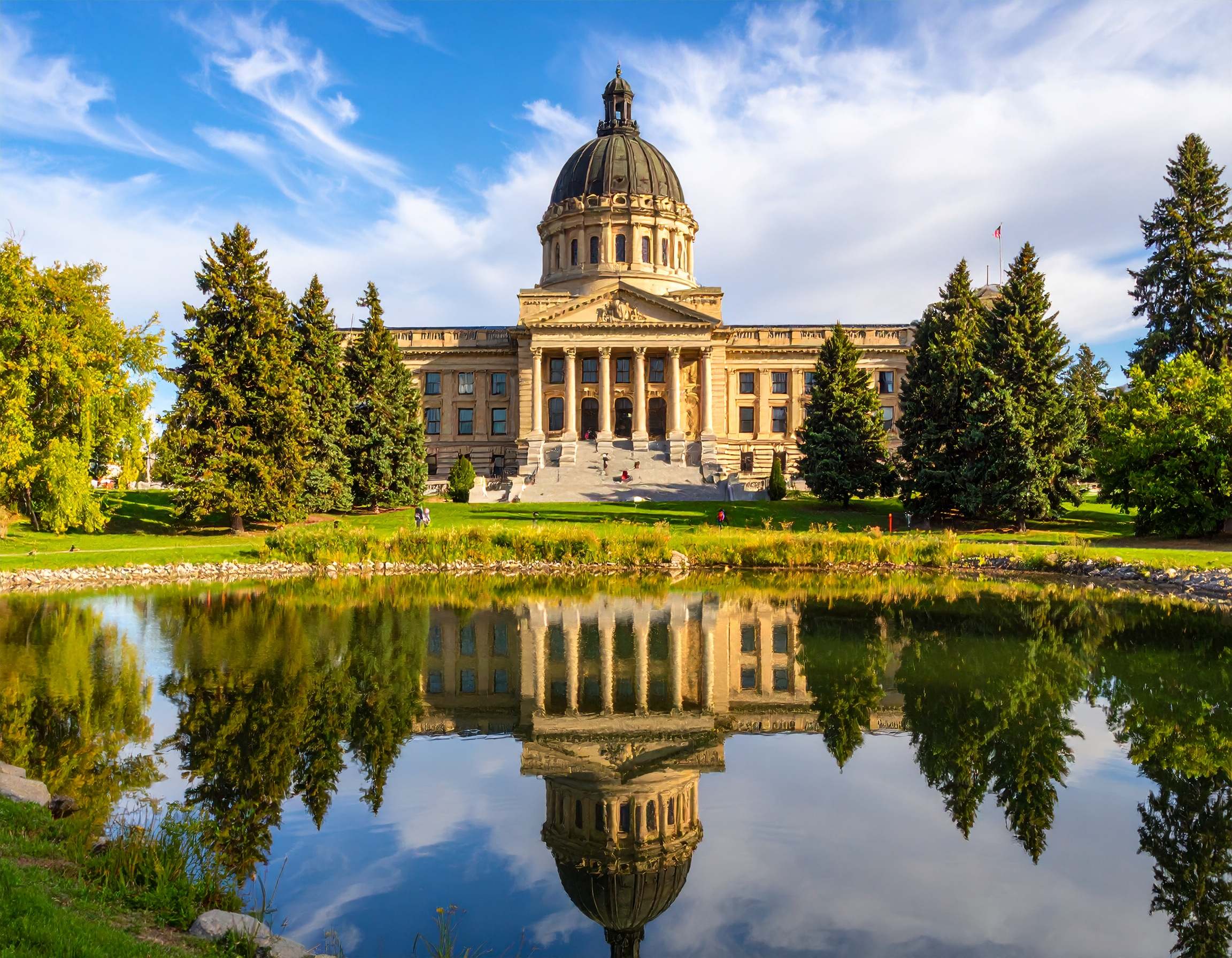 Alberta Legislature building with reflection in water